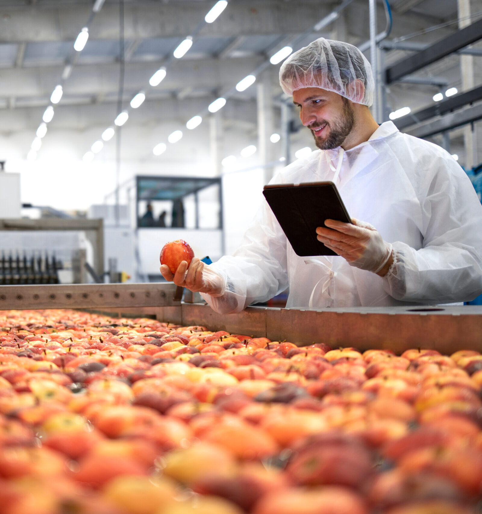 man in a labcoat looking at fruit