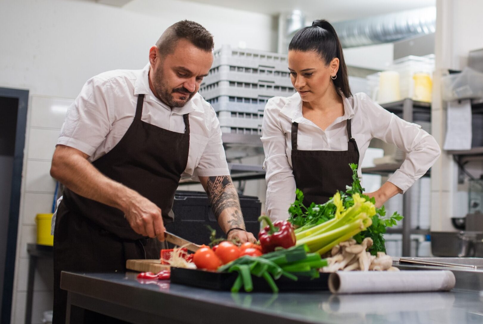 man and woman chopping vegetables