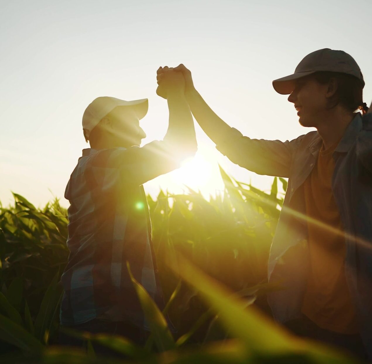 man and woman high fiving in field