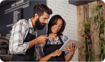 2 waiters looking at ipad in restaurant