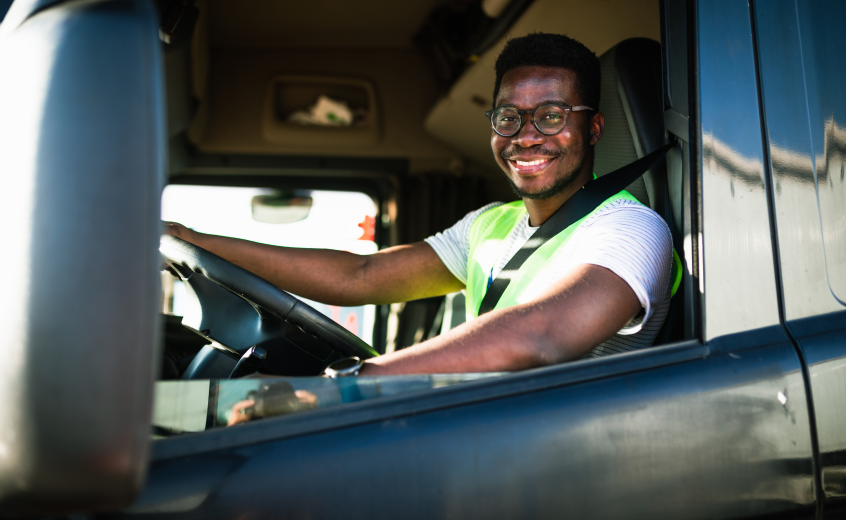 man smiling driving truck